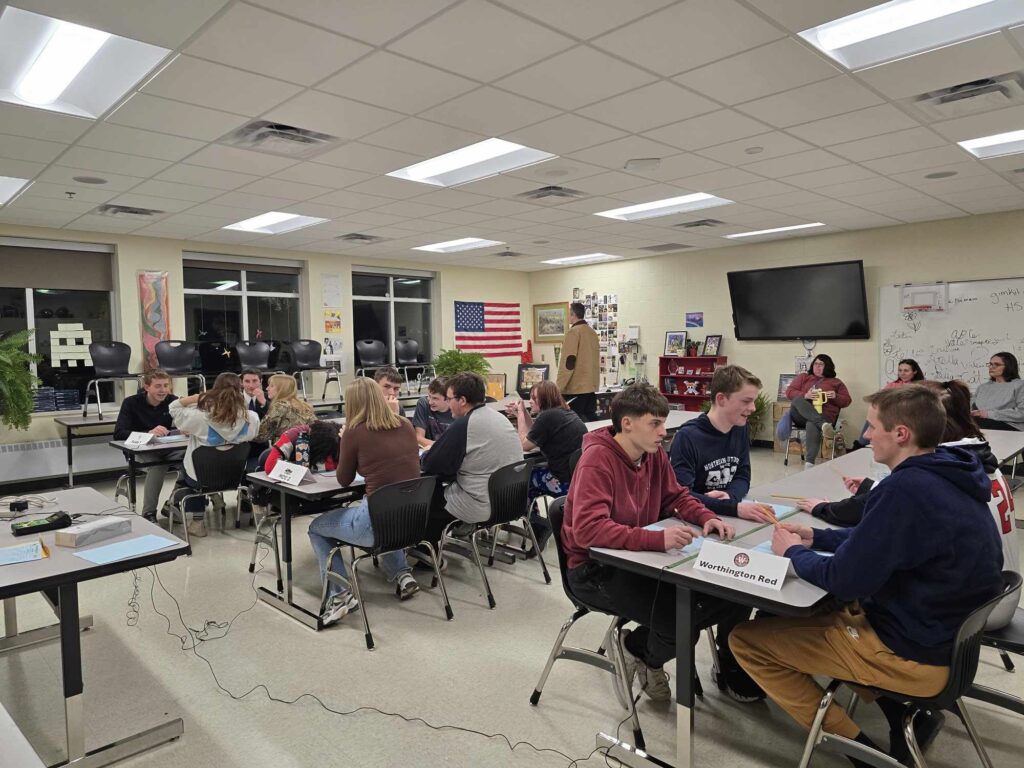 Students at tables sitting in groups of 4