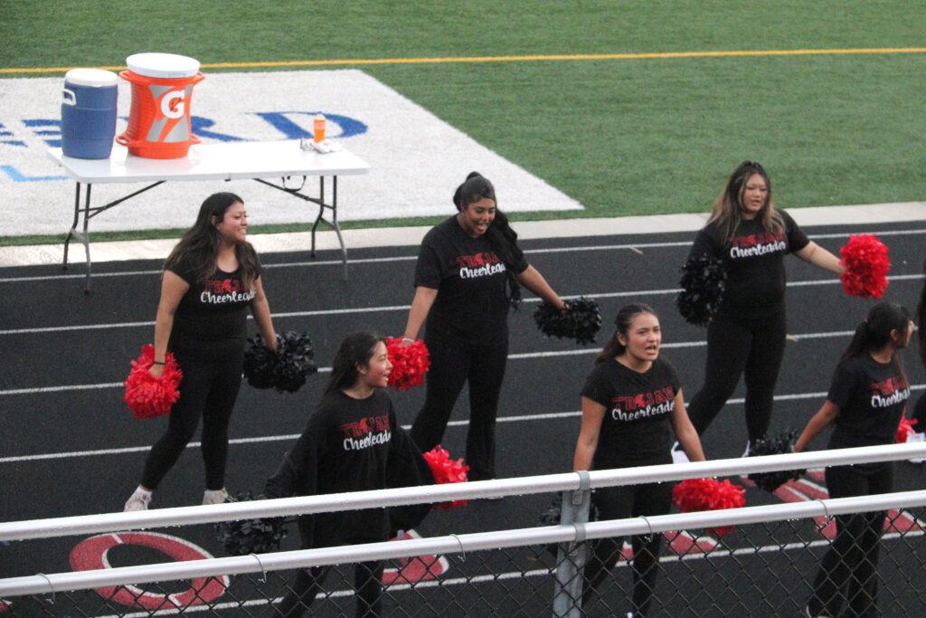 Cheerleading at football game.