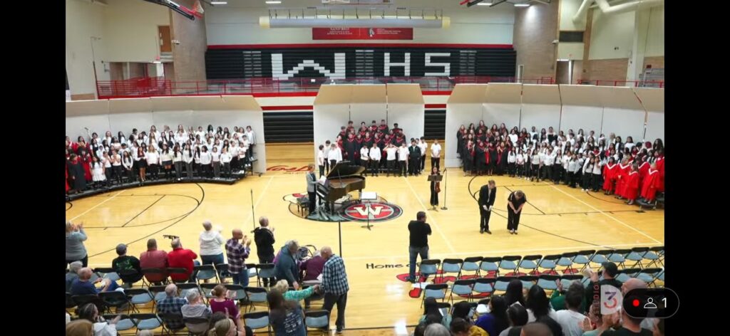 Three choirs in the gym before an audience